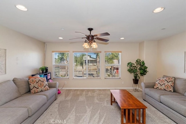 carpeted living room with ceiling fan