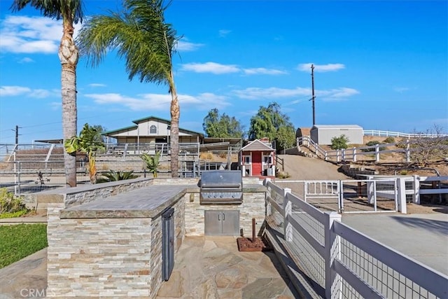 view of patio featuring grilling area and an outdoor kitchen