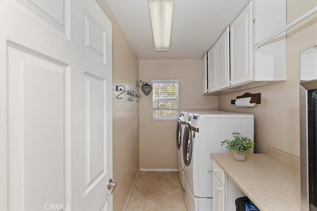 washroom featuring cabinets and separate washer and dryer