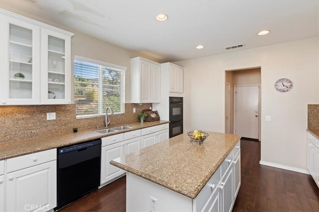 kitchen featuring sink, white cabinetry, and black appliances