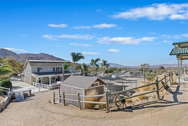 view of horse barn with a mountain view