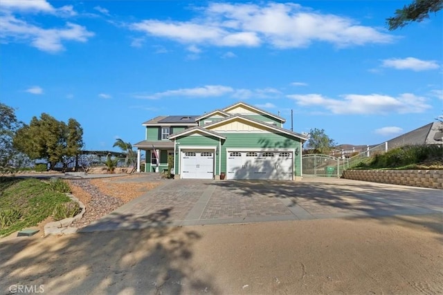 view of front of home featuring a garage and solar panels