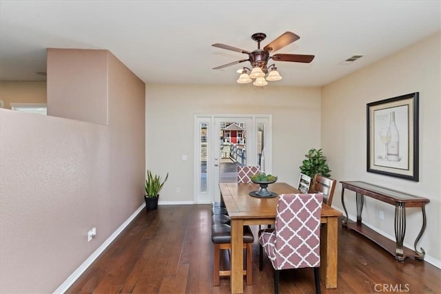 dining area with ceiling fan and dark hardwood / wood-style floors