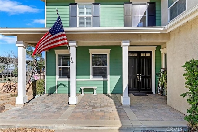 property entrance with covered porch