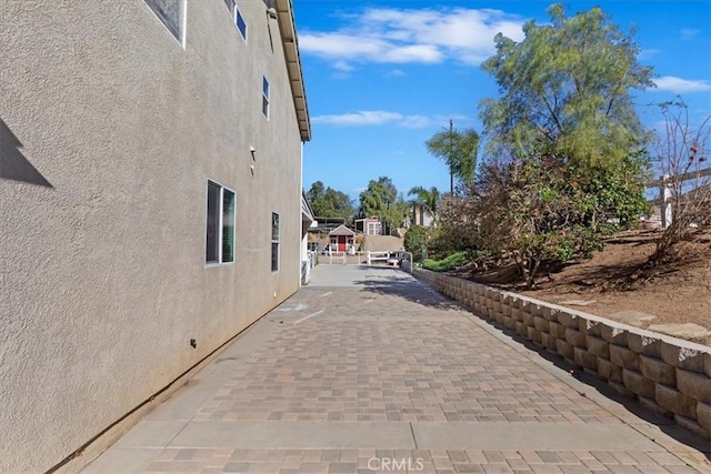 view of side of property with a patio area