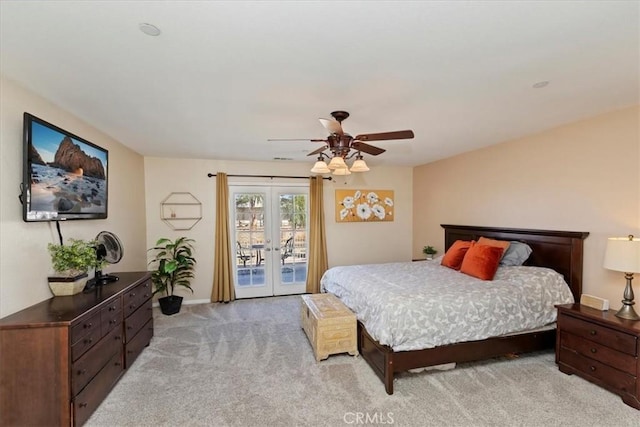 carpeted bedroom with access to outside, ceiling fan, and french doors