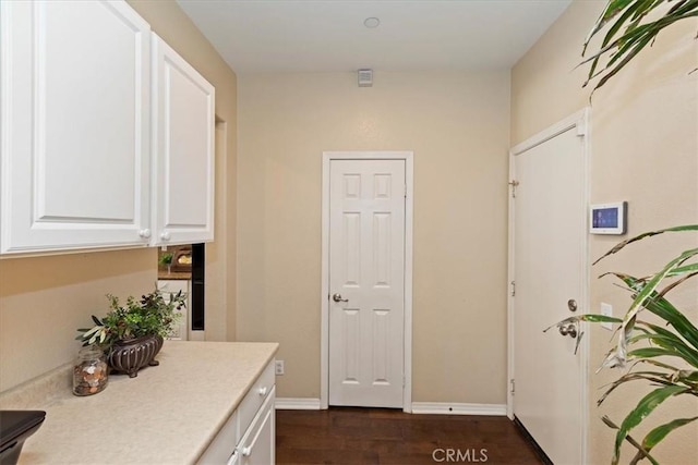 hallway with dark hardwood / wood-style floors