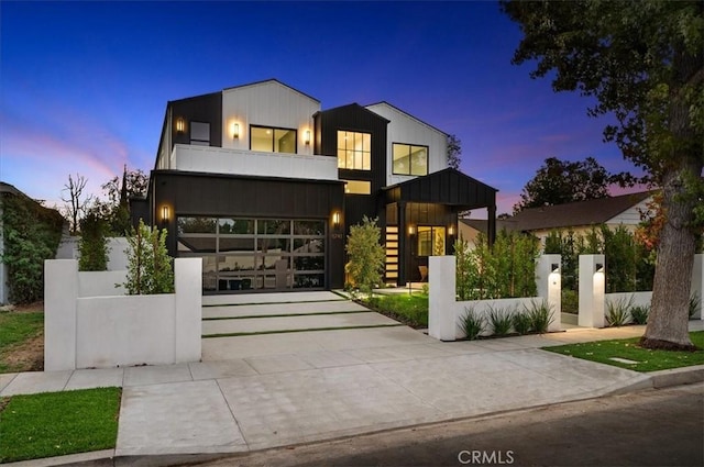 contemporary home featuring a balcony and a garage