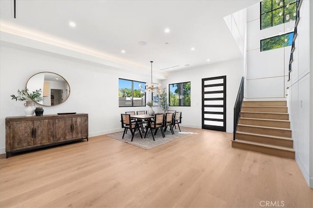 dining room featuring an inviting chandelier and light hardwood / wood-style flooring