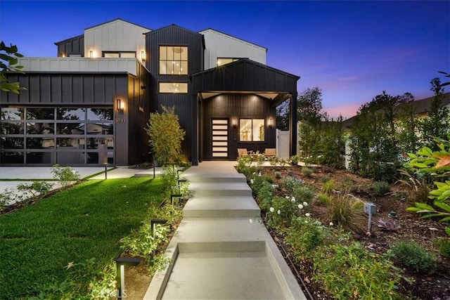 modern home featuring a lawn and a garage