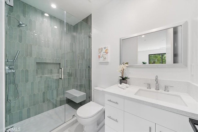 bathroom with vanity, an enclosed shower, and toilet