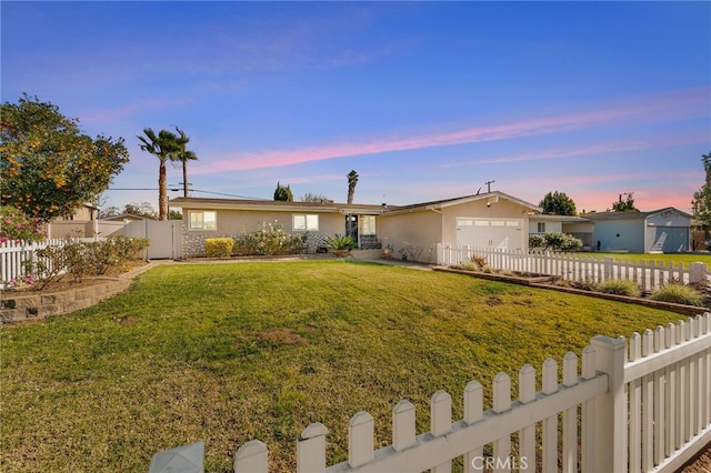 single story home with a garage and a yard