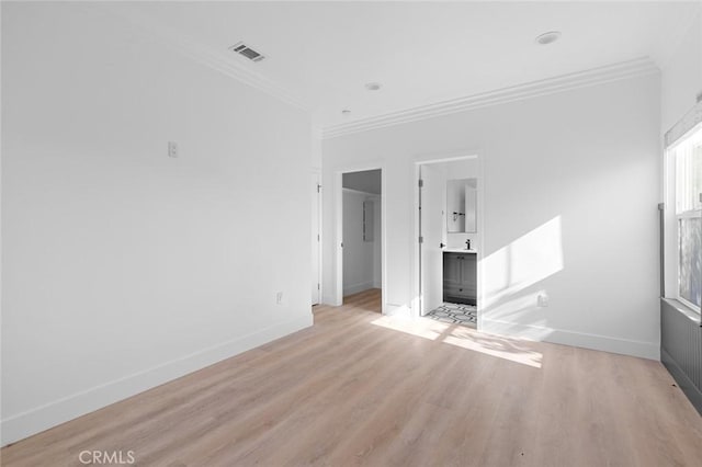 unfurnished living room with light hardwood / wood-style floors and ornamental molding