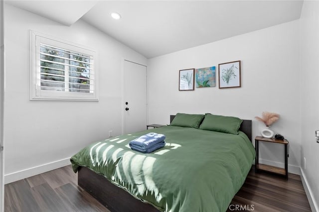 bedroom featuring dark wood-type flooring and lofted ceiling