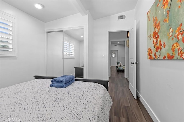 bedroom with dark hardwood / wood-style flooring