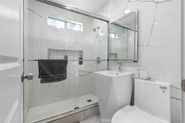 bathroom featuring toilet and walk in shower