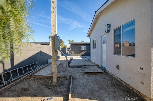 view of side of home featuring a patio area