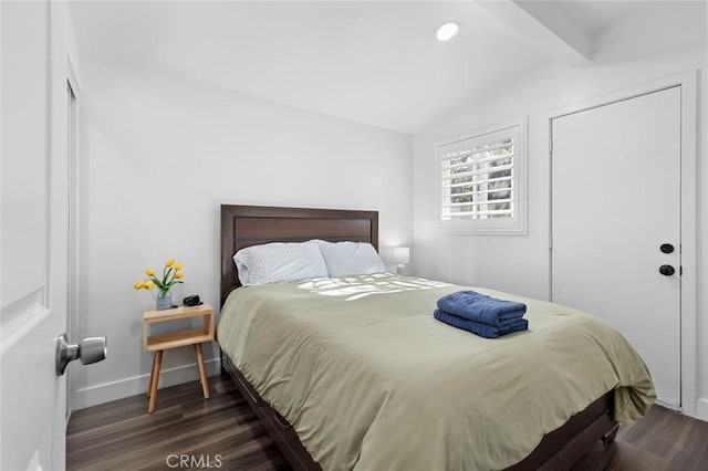 bedroom featuring lofted ceiling with beams and dark wood-type flooring