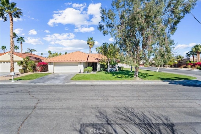 view of front of house with a front yard and a garage