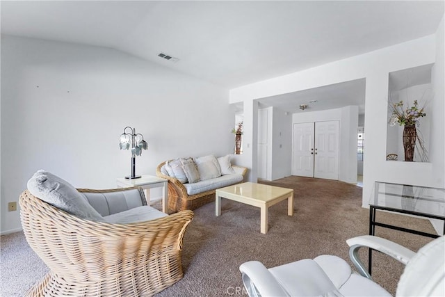 carpeted living room featuring lofted ceiling