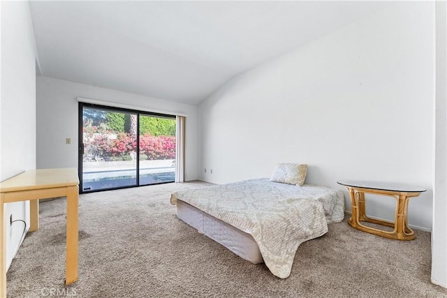 bedroom with access to exterior, carpet flooring, and vaulted ceiling