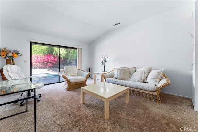 living room featuring carpet flooring and vaulted ceiling