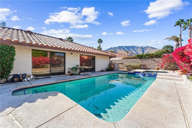 view of swimming pool with a mountain view and a patio area