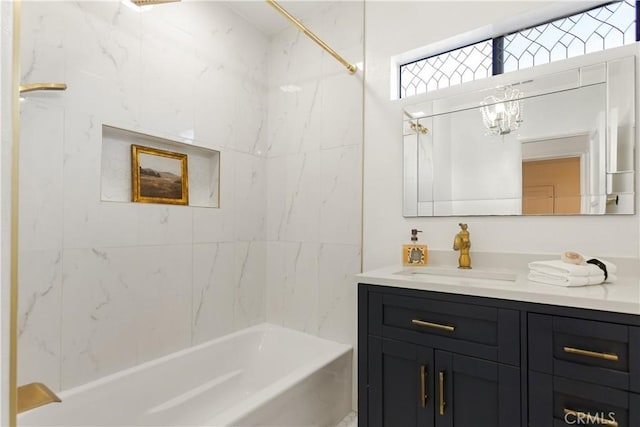 bathroom with tiled shower / bath combo and vanity