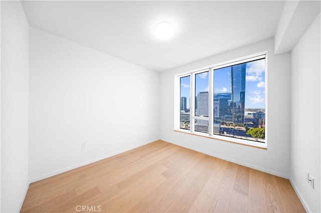 unfurnished room with light hardwood / wood-style floors