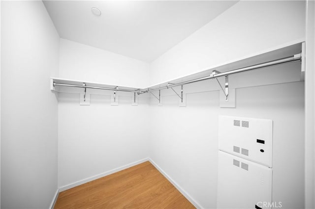 walk in closet with hardwood / wood-style floors