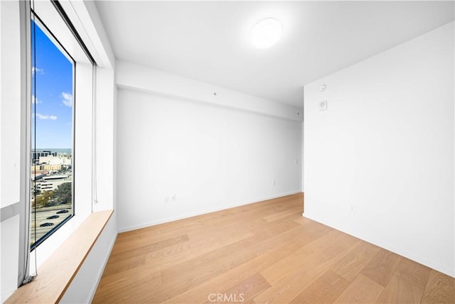 spare room with light hardwood / wood-style flooring