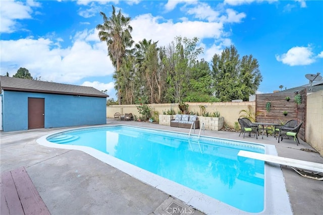 view of pool featuring a patio and a diving board