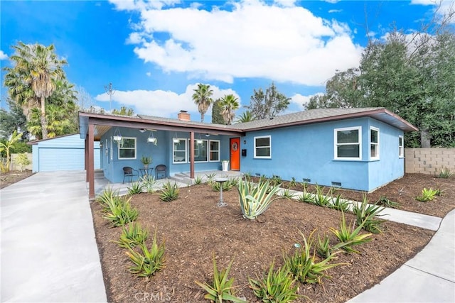 ranch-style home with an outbuilding, a chimney, covered porch, crawl space, and a garage