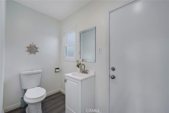 bathroom featuring hardwood / wood-style flooring, vanity, and toilet