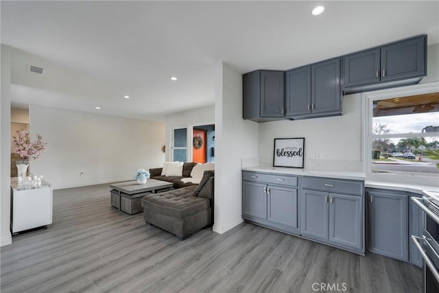 kitchen featuring stainless steel range oven and light hardwood / wood-style floors