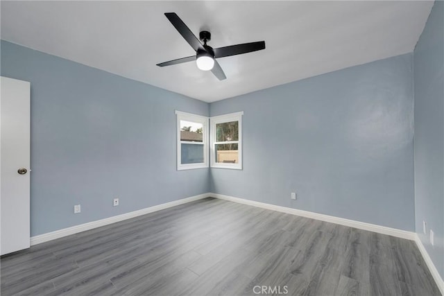 spare room featuring hardwood / wood-style floors and ceiling fan