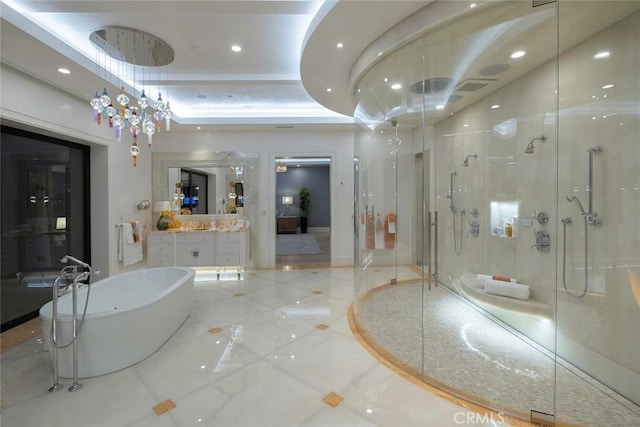 bathroom with vanity, plus walk in shower, and a tray ceiling