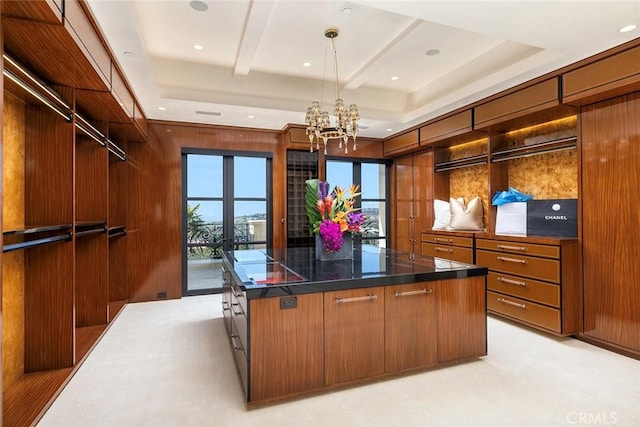 spacious closet with french doors and a notable chandelier