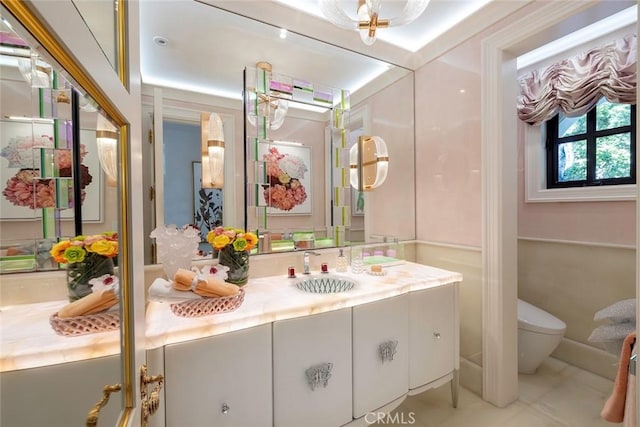 bathroom featuring tile patterned flooring, vanity, and toilet