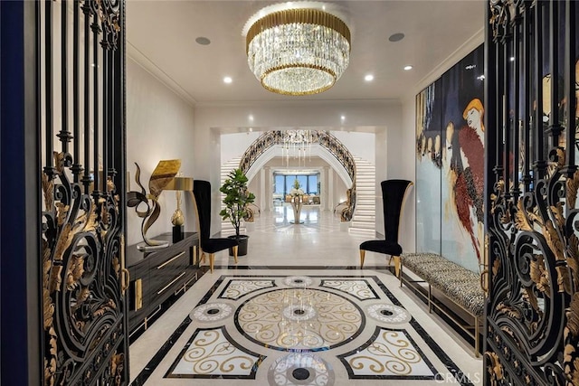 tiled foyer entrance with an inviting chandelier and ornamental molding