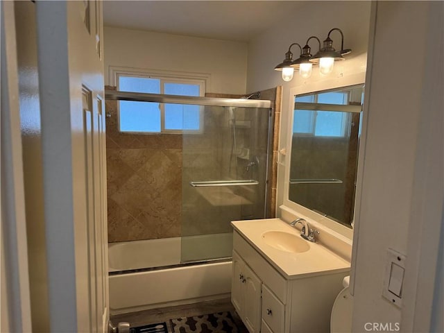 bathroom with combined bath / shower with glass door and vanity