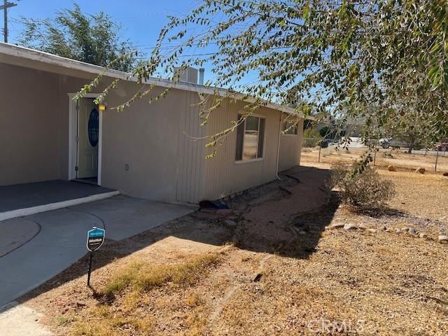 view of side of property featuring a patio area