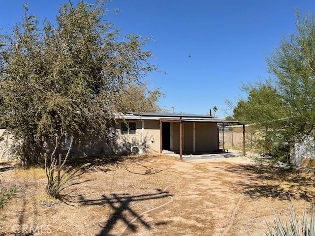 rear view of property featuring a patio area