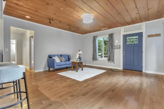 sitting room featuring wood-type flooring, wooden ceiling, and ornamental molding