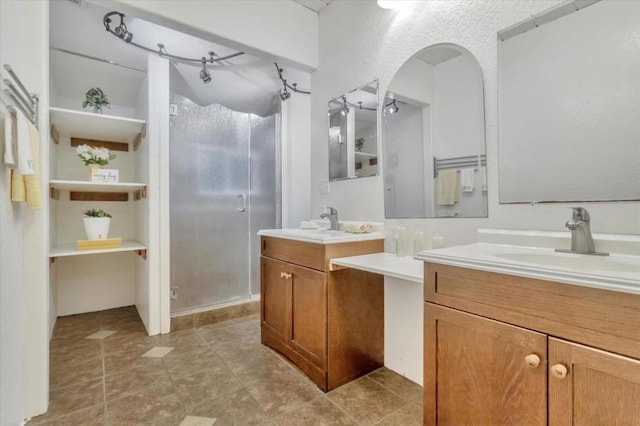 bathroom featuring an enclosed shower and vanity