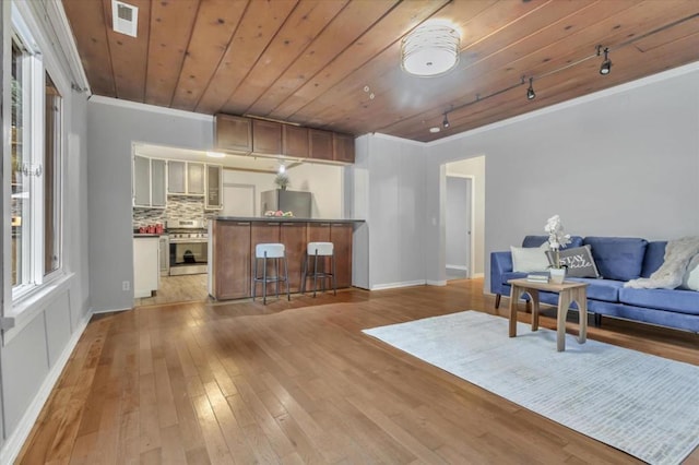 living room featuring ornamental molding, light hardwood / wood-style floors, and wooden ceiling