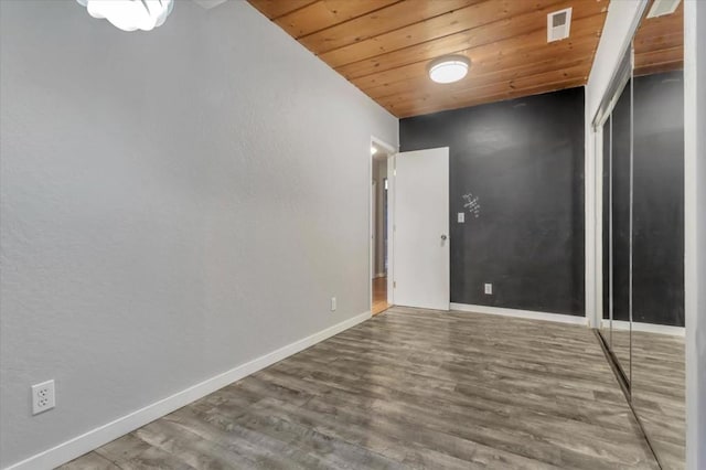 unfurnished room featuring wooden ceiling and hardwood / wood-style floors