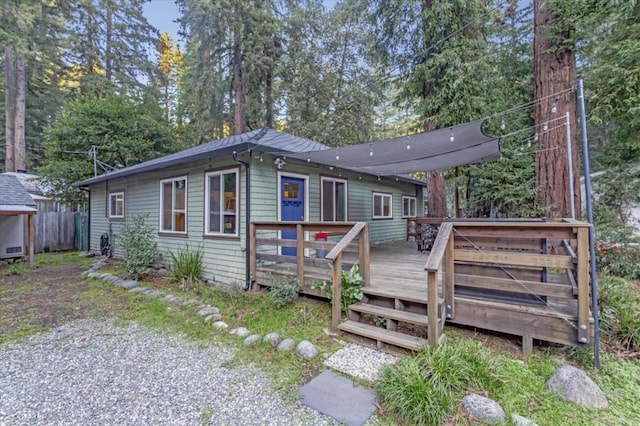 back of house with a wooden deck