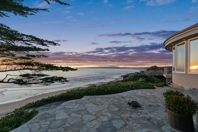 patio terrace at dusk with a water view