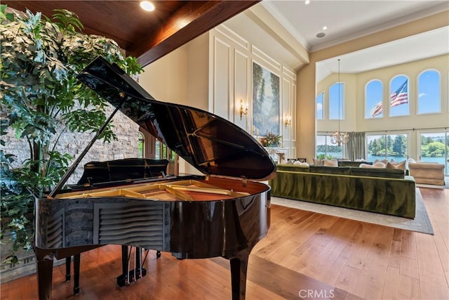 misc room with a chandelier, hardwood / wood-style floors, and crown molding